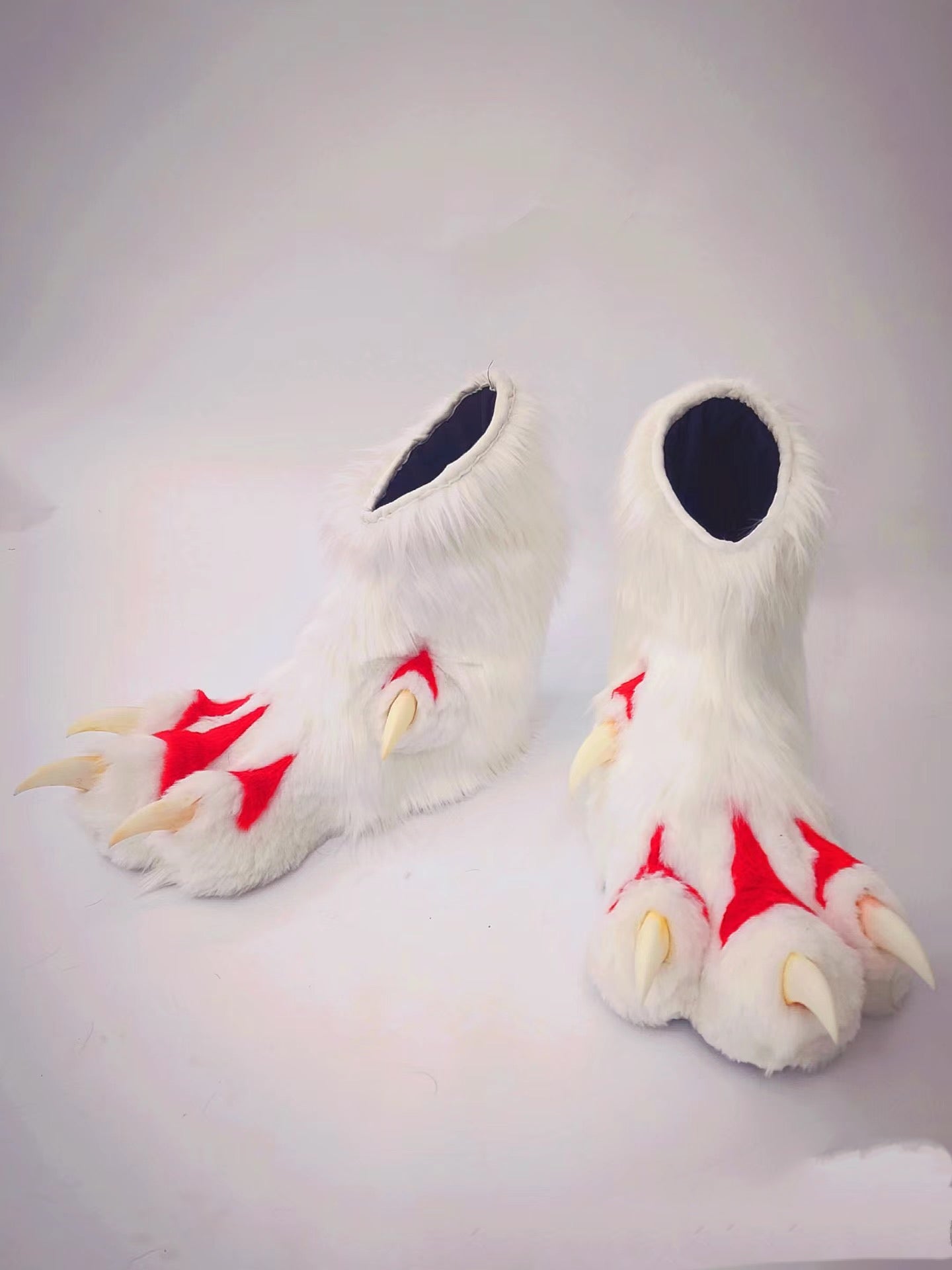 Paw feet made of red and white faux fur patchwork for a fursuit; color customization available.
