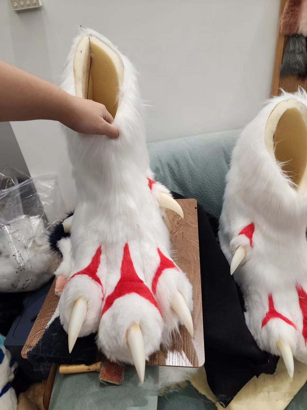 Paw feet made of red and white faux fur patchwork for a fursuit; color customization available.