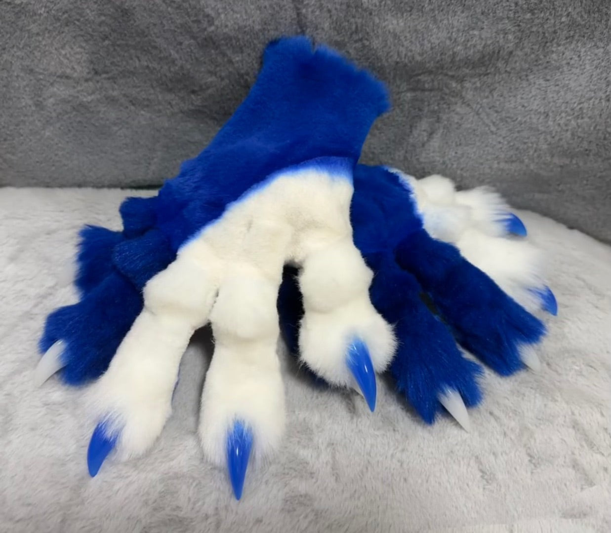 Blue and white color-blocked, hand-attached, realistic paws, furry fursuit, customizable colors, made with stretchy synthetic fabric combined with faux fur fabric.